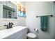 Bathroom with a vanity sink, toilet, mirror and towel bar, offering functionality and style at 610 Cottage Ln, Lakeland, FL 33803
