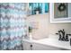 Charming bathroom featuring stylish shower curtain, vanity, and decor for a cozy feel at 610 Cottage Ln, Lakeland, FL 33803