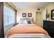 Inviting bedroom featuring a comfortable bed, window, and tasteful decor for a relaxing space at 610 Cottage Ln, Lakeland, FL 33803