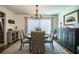 Traditional dining room with a round table, woven chairs, chandelier, and sliding glass door with light-filtering blinds at 610 Cottage Ln, Lakeland, FL 33803
