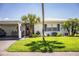Charming home featuring a well-maintained lawn, landscaping, and a convenient carport at 610 Cottage Ln, Lakeland, FL 33803