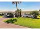 Charming single-story home with a pristine lawn, carport, and tropical landscaping at 610 Cottage Ln, Lakeland, FL 33803