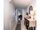 Inviting hallway with tiled flooring, decorative furnishings, and a glimpse of other rooms at 610 Cottage Ln, Lakeland, FL 33803