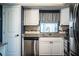 Well-lit kitchen showcasing stainless steel appliances, white cabinets, and granite countertops at 610 Cottage Ln, Lakeland, FL 33803