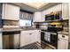 Well-appointed kitchen with stainless steel appliances, white cabinets, and tile backsplash at 610 Cottage Ln, Lakeland, FL 33803
