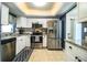 Bright kitchen featuring stainless steel appliances, white cabinetry, and stylish countertops at 610 Cottage Ln, Lakeland, FL 33803