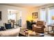 Open-concept living space with a cozy sitting area, a desk nook, and a view into the dining room at 610 Cottage Ln, Lakeland, FL 33803
