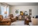 Comfortable living room with recliner seating, a TV, a wooden coffee table, and decorative wall art at 610 Cottage Ln, Lakeland, FL 33803