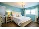 Calming main bedroom featuring a white bed, a bedside table with a lamp, and natural light from the window at 610 Cottage Ln, Lakeland, FL 33803