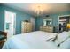 Bright main bedroom with access to ensuite bathroom, white furnishings, light blue walls, and wood laminate flooring at 610 Cottage Ln, Lakeland, FL 33803