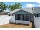 Backyard view showcasing a screened porch and white fence surrounding the property at 6315 Conductor Ct, Lakeland, FL 33813