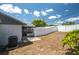 Backyard with white fence, air conditioner unit, patio, and a screened in porch at 6315 Conductor Ct, Lakeland, FL 33813