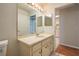 Bathroom featuring a mirror with vanity lighting, sink, and view to the kitchen at 6315 Conductor Ct, Lakeland, FL 33813