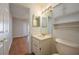 Well-lit bathroom with a vanity, mirror, and convenient storage shelves at 6315 Conductor Ct, Lakeland, FL 33813