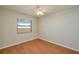 The bedroom features wood floors, a ceiling fan, and a window with a view to the outside at 6315 Conductor Ct, Lakeland, FL 33813
