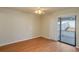 Bedroom with wood floors, ceiling fan, and a sliding glass door leading to the outside at 6315 Conductor Ct, Lakeland, FL 33813