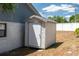 Outdoor shed for storage with a white door, located on the side of the home at 6315 Conductor Ct, Lakeland, FL 33813