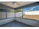 View of the screened porch with a ceiling fan and view of the white fenced-in backyard at 6315 Conductor Ct, Lakeland, FL 33813