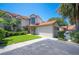 Charming home featuring a red tile roof, a well-manicured lawn, and a private garage, under a clear blue sky at 71 Sunset View Dr # 71, Winter Haven, FL 33884