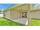 Covered back patio overlooking the green lawn of the backyard at 803 Allison Place, Bartow, FL 33830