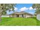 Backyard featuring a well-maintained lawn and a covered back patio at 803 Allison Place, Bartow, FL 33830