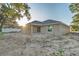 Exterior of the home with a covered patio, sliding glass doors, and bright sunny day at 803 Allison Place, Bartow, FL 33830
