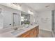 Bathroom featuring double sink vanity, modern lighting, mirror and doorway to shower at 803 Allison Place, Bartow, FL 33830