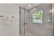 Modern bathroom with glass-enclosed shower, tiled walls, and pebble-style shower floor at 803 Allison Place, Bartow, FL 33830