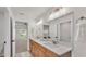 Bathroom with double sink vanity, modern lighting, and doorway to bedroom at 803 Allison Place, Bartow, FL 33830