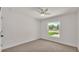 Bedroom with neutral carpet, white trim, and a bright window with outdoor view at 803 Allison Place, Bartow, FL 33830