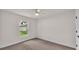 Bright bedroom featuring neutral carpet, a ceiling fan, and a bright window at 803 Allison Place, Bartow, FL 33830