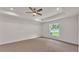 Minimalist carpeted bedroom with a ceiling fan, a tray ceiling, recessed lighting, and a large window at 803 Allison Place, Bartow, FL 33830