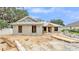 Home under construction with visible block framework, window openings and lumber on the lot at 803 Allison Place, Bartow, FL 33830