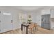 Dining area with a modern table setting, stainless steel refrigerator, and ample natural light at 803 Allison Place, Bartow, FL 33830