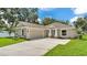Attractive single-Gathering home with a spacious driveway leading to a two-car garage, and stone facade accents at 803 Allison Place, Bartow, FL 33830