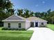 Charming single-story home with a well-manicured lawn, stone accents, and a welcoming front entrance at 803 Allison Place, Bartow, FL 33830
