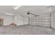 Spacious two car garage with high ceilings, white walls, and concrete floors at 803 Allison Place, Bartow, FL 33830