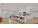 Bright, open kitchen with quartz counters, stainless appliances, and a breakfast bar that overlooks the dining area at 803 Allison Place, Bartow, FL 33830