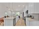 Bright kitchen with white cabinets, stainless steel appliances, quartz countertops, and modern backsplash design at 803 Allison Place, Bartow, FL 33830