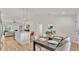 Open-concept kitchen features a center island, pendant lighting, modern appliances, and an adjacent dining area at 803 Allison Place, Bartow, FL 33830