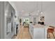Spacious kitchen with stainless steel appliances, pendant lighting, a center island with counter seating, and an open floor plan at 803 Allison Place, Bartow, FL 33830