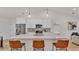Modern kitchen featuring a large center island with bar seating, stainless steel appliances, and pendant lighting at 803 Allison Place, Bartow, FL 33830