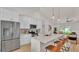 Updated kitchen features stainless steel appliances, white cabinets, a center island with seating, and pendant lighting at 803 Allison Place, Bartow, FL 33830