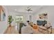Bright living room showcasing modern furnishings, a ceiling fan, and sliding glass doors to the outdoor space at 803 Allison Place, Bartow, FL 33830