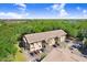 Scenic aerial view of the complex with ample parking, lush landscaping, and beautiful surrounding trees at 8838 Coral Palms Ct # A, Kissimmee, FL 34747
