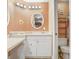 Well-lit bathroom features a vanity area with additional storage and a toilet at 8838 Coral Palms Ct # A, Kissimmee, FL 34747