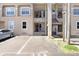 A two-story apartment building showing unit entrances and on-site parking spaces at 8838 Coral Palms Ct # A, Kissimmee, FL 34747