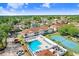 Aerial view of the community pool and tennis courts surrounded by residences at 8838 Coral Palms Ct # A, Kissimmee, FL 34747