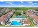 Aerial view of the community pool and tennis courts surrounded by residences at 8838 Coral Palms Ct # A, Kissimmee, FL 34747