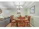 Dining area featuring a round table, seating for six, and elegant overhead lighting at 8838 Coral Palms Ct # A, Kissimmee, FL 34747
